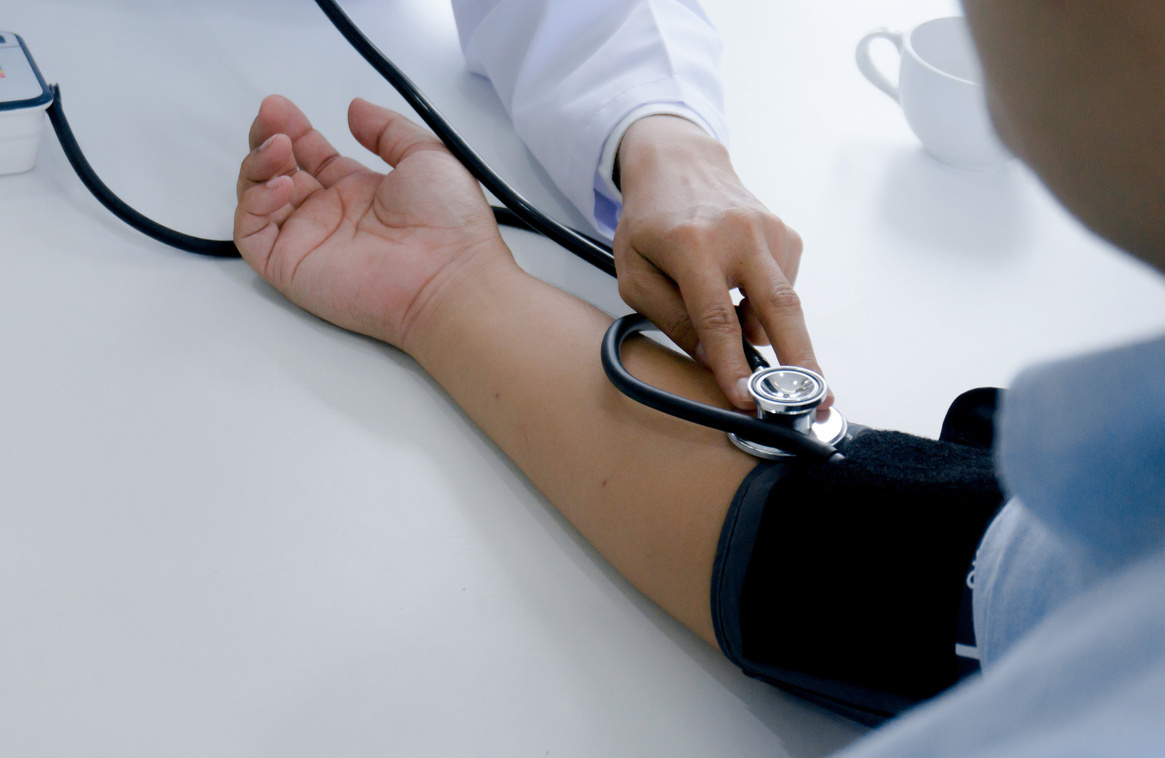 Doctor checking old woman patient arterial blood pressure. Healt